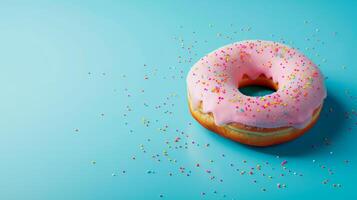 AI generated Sprinkled pink donut over blue background. Delicious frosted sprinkled donut isolated. photo