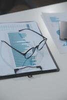 Financial analysts analyze business financial reports on a digital tablet planning investment project during a discussion at a meeting of corporate showing the results of their successful teamwork. photo