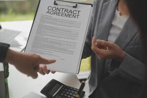 Business Signing a Contract Buy - sell house, insurance agent analyzing about home investment loan Real Estate concept. photo