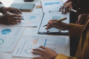Financial analysts analyze business financial reports on a digital tablet planning investment project during a discussion at a meeting of corporate showing the results of their successful teamwork. photo