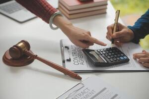Lawyer, legal advisor, businessman brainstorming information on agreement details Business contracts in legal processing books for accuracy in contract documents. joint financial investment. photo