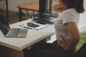 Shot of a asian young business Female working on laptop in her workstation. photo