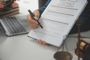 Lawyer, legal advisor, businessman brainstorming information on agreement details Business contracts in legal processing books for accuracy in contract documents. joint financial investment. photo