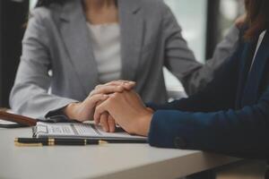 Lawyer, legal advisor, businessman brainstorming information on agreement details Business contracts in legal processing books for accuracy in contract documents. joint financial investment. photo