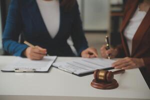 Lawyer, legal advisor, businessman brainstorming information on agreement details Business contracts in legal processing books for accuracy in contract documents. joint financial investment. photo