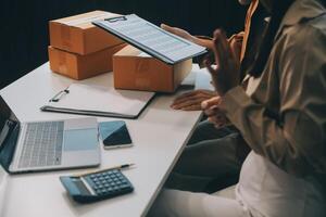 mujer de negocios comienzo pequeño negocio y exitoso SME empresarios asiático mujer hoding cajas trabajos desde hogar entregando parcelas en línea. SME entrega concepto y embalaje foto