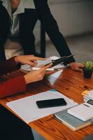 Entrepreneurs and business people conference in modern meeting room, happy multiracial coworkers have fun cooperating working together at office meeting, asian teamwork concept photo