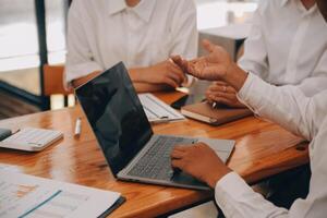 Entrepreneurs and business people conference in modern meeting room, happy multiracial coworkers have fun cooperating working together at office meeting, asian teamwork concept photo