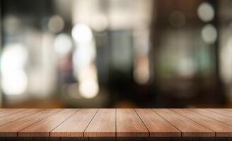 Empty wooden table top with lights bokeh on blur restaurant background. photo