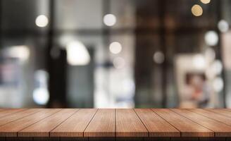 Empty wooden table top with lights bokeh on blur restaurant background. photo