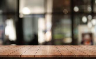 Empty wooden table top with lights bokeh on blur restaurant background. photo