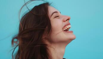 AI generated Young woman laughs against a blue background. photo