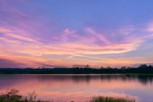 Serene Waters A Blissful Reflection of a Beautiful Pastel Lake and Sky, Where Tranquility Meets Nature's Palette, Creating a Harmonious Oasis of Soft Hues and Ethereal Beauty photo