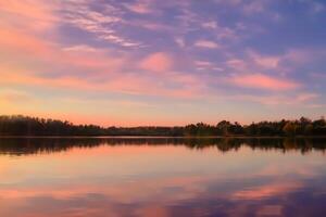 sereno aguas un feliz reflexión de un hermosa pastel lago y cielo, dónde tranquilidad Satisface de la naturaleza paleta, creando un armonioso oasis de suave matices y etéreo belleza foto