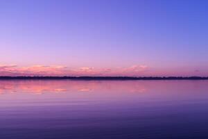 Serene Waters A Blissful Reflection of a Beautiful Pastel Lake and Sky, Where Tranquility Meets Nature's Palette, Creating a Harmonious Oasis of Soft Hues and Ethereal Beauty photo