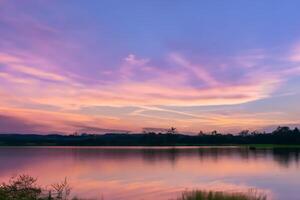 Serene Waters A Blissful Reflection of a Beautiful Pastel Lake and Sky, Where Tranquility Meets Nature's Palette, Creating a Harmonious Oasis of Soft Hues and Ethereal Beauty photo