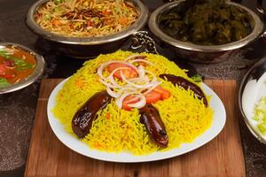 Embark on a Culinary Journey with the Exquisite Aroma and Flavorful Bliss of Kebuli Rice, a Fragrant Middle Eastern Dish Infused with Spices and Savory Perfection, Offering Gastronomic Joy. photo