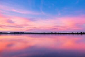 Serene Waters A Blissful Reflection of a Beautiful Pastel Lake and Sky, Where Tranquility Meets Nature's Palette, Creating a Harmonious Oasis of Soft Hues and Ethereal Beauty photo