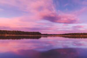 Serene Waters A Blissful Reflection of a Beautiful Pastel Lake and Sky, Where Tranquility Meets Nature's Palette, Creating a Harmonious Oasis of Soft Hues and Ethereal Beauty photo