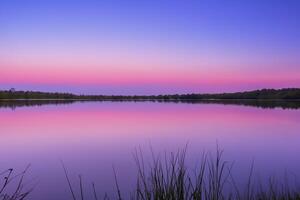 Serene Waters A Blissful Reflection of a Beautiful Pastel Lake and Sky, Where Tranquility Meets Nature's Palette, Creating a Harmonious Oasis of Soft Hues and Ethereal Beauty photo