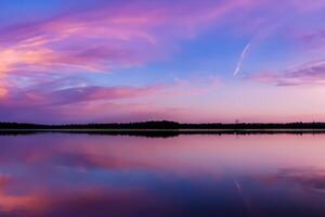 Serene Waters A Blissful Reflection of a Beautiful Pastel Lake and Sky, Where Tranquility Meets Nature's Palette, Creating a Harmonious Oasis of Soft Hues and Ethereal Beauty photo