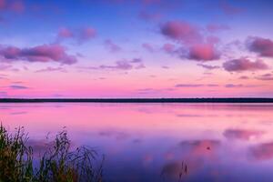 Serene Waters A Blissful Reflection of a Beautiful Pastel Lake and Sky, Where Tranquility Meets Nature's Palette, Creating a Harmonious Oasis of Soft Hues and Ethereal Beauty photo