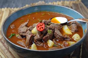 Savor the Exquisite Lamb or Beef Curry Rendang, Ready to Be Relished on Eid al-Adha, Capturing the Essence of Celebration in a Perfect Photo, Showcasing Culinary Mastery and Festive Indulgence photo
