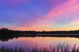 Serene Waters A Blissful Reflection of a Beautiful Pastel Lake and Sky, Where Tranquility Meets Nature's Palette, Creating a Harmonious Oasis of Soft Hues and Ethereal Beauty photo