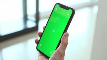 mobil telefon grön skärm i hand, använder sig av mobil telefon i kontor video