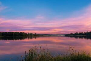 Serene Waters A Blissful Reflection of a Beautiful Pastel Lake and Sky, Where Tranquility Meets Nature's Palette, Creating a Harmonious Oasis of Soft Hues and Ethereal Beauty photo