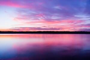 Serene Waters A Blissful Reflection of a Beautiful Pastel Lake and Sky, Where Tranquility Meets Nature's Palette, Creating a Harmonious Oasis of Soft Hues and Ethereal Beauty photo