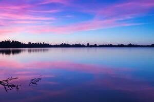 Serene Waters A Blissful Reflection of a Beautiful Pastel Lake and Sky, Where Tranquility Meets Nature's Palette, Creating a Harmonious Oasis of Soft Hues and Ethereal Beauty photo