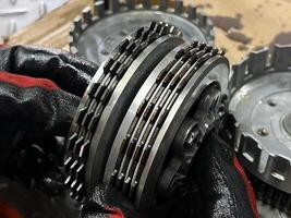 maintenance of motorcycle engine clutch system.  repair and maintenance motorcycle concept. photo