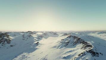 Snowy mountain range bathed in sunlight video