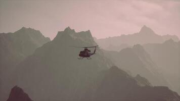 A helicopter is flying over a mountain range video