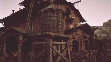 An antique wooden building surrounded by a rustic wooden fence video