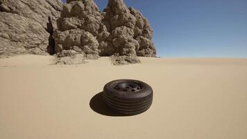 A tire sitting in the middle of a desert video
