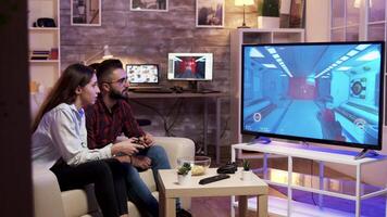 Couple relaxing together playing video games on television,