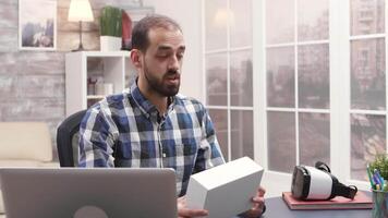 Young influencer holding a box while recording a vlog. Vlogger talking with subscribers. video