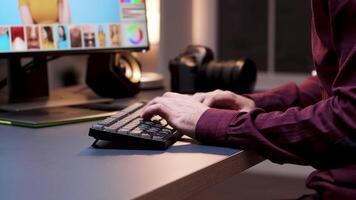 Closeup of young photographer using keyboard. Creative retouching. video