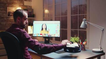 Freelancer photographerworks on photos using modern retouching software in home office during night time. video