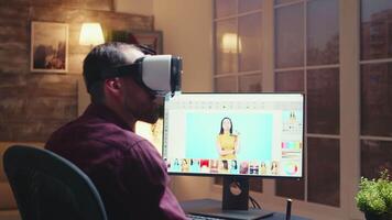 Freelancer photographer using virtual reality headset while retouching photos with graphic tablet in home office during night time. video