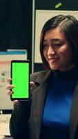 Vertical Video Investigator showing greenscreen layout on smartphone display, working at a private federal company. Detective solving criminal case while using phone with chromakey layout and mockup. Camera A.