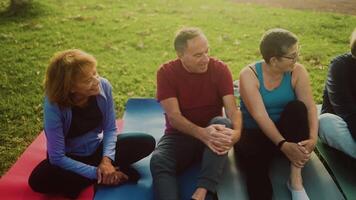 a group of senior people sitting on the grass video