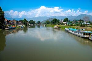 Dal Lake and the beautiful mountain range in the background in the summer Boat Trip of city Srinagar Kashmir India. photo