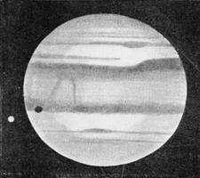 Jupiter with one of his five moons whose shadow is visible on the planet, vintage engraving. photo