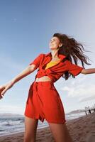 Smiling Woman Dancing in the Summer Breeze. Joyful Emotions on the Beach photo