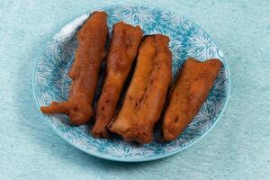 deep fried brinjal pakora or beguni served in a dish isolated on background top view of Indian and bengali food photo