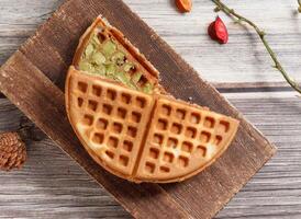 Red Bean Matcha waffle served on wooden board isolated on table top view of dessert photo