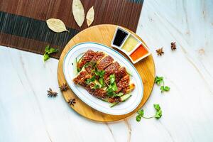 Roasted Chicken slice with sauces served in dish isolated on wooden board top view on marble background hong kong food photo